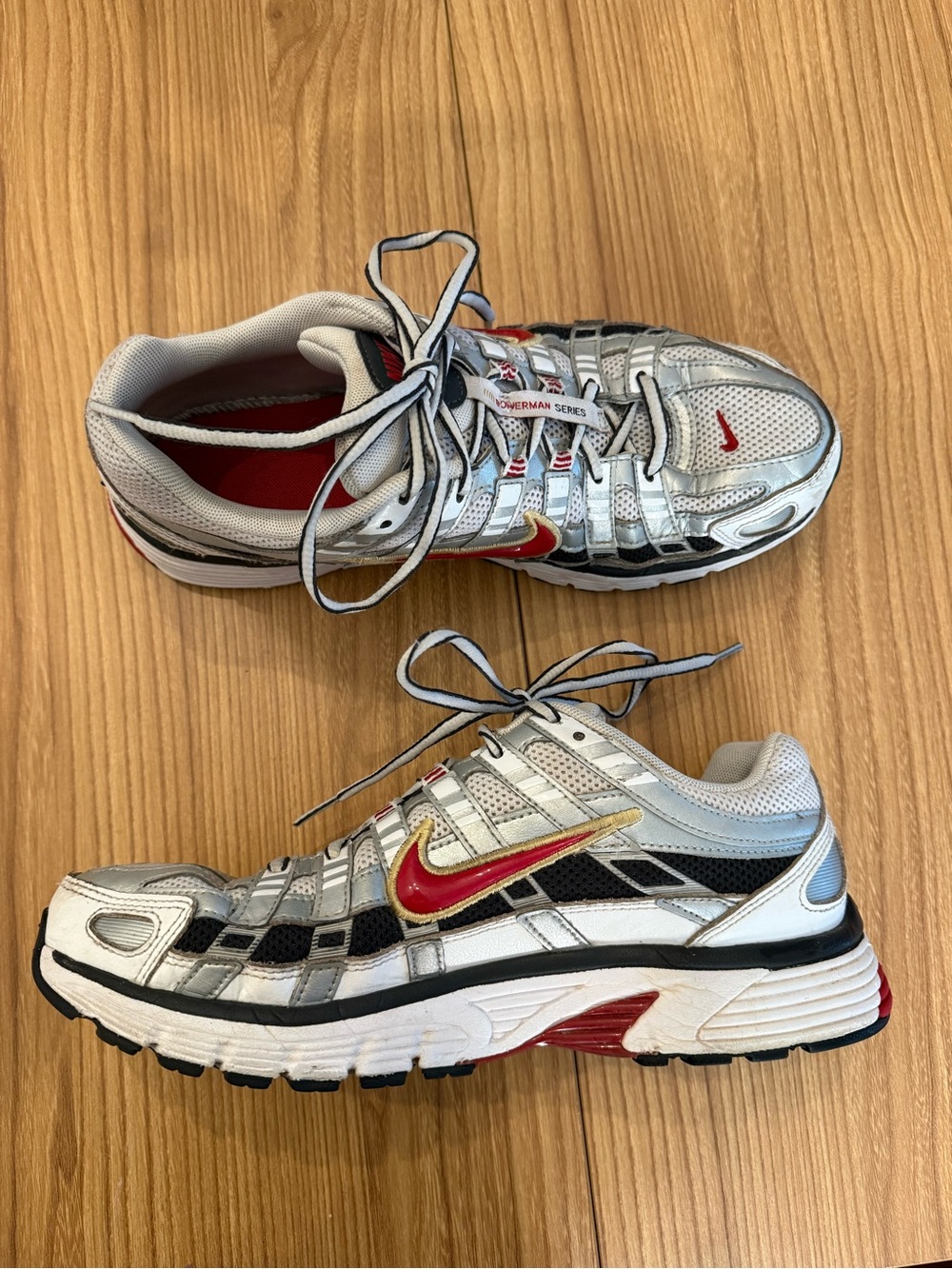 Nike Silver Athletic Shoes with Red and Gold Swoosh